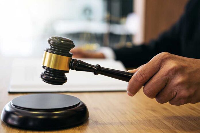 1023698749 featured image Gavel in judge's hand about to strike.