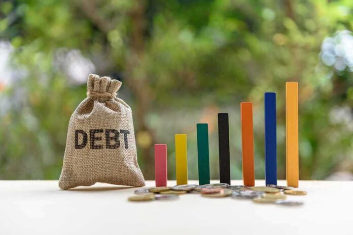 1131624908 featured image Debt sack with rising financial graph bars.