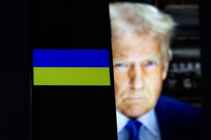 shutterstock_2576538235.jpg featured image Ukraine flag on smartphone with President Donald Trump behind it