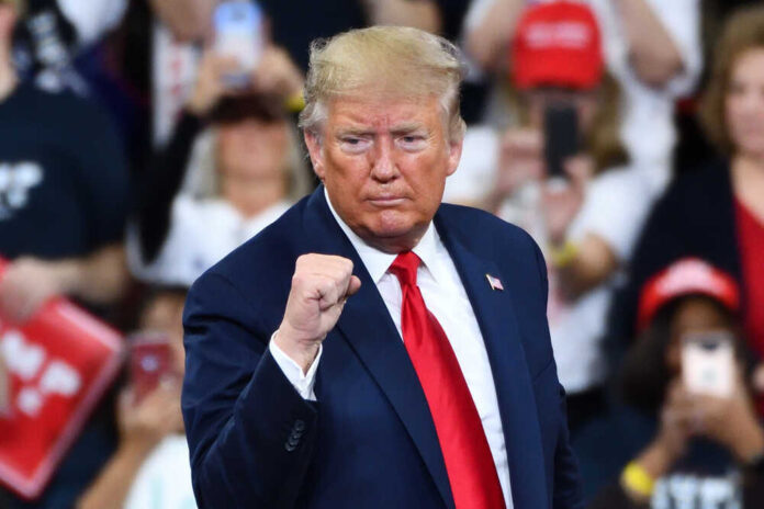 shutterstock_1585235176.jpg featured image Donald Trump at a rally, raising his fist.