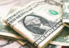 U.S. dollar bills with George Washington visible.
