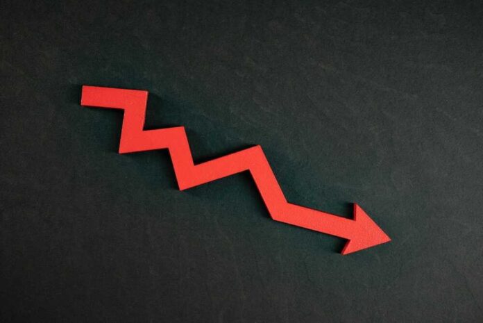 shutterstock_2036789366.jpg featured image Red zigzag arrow pointing down on dark background.