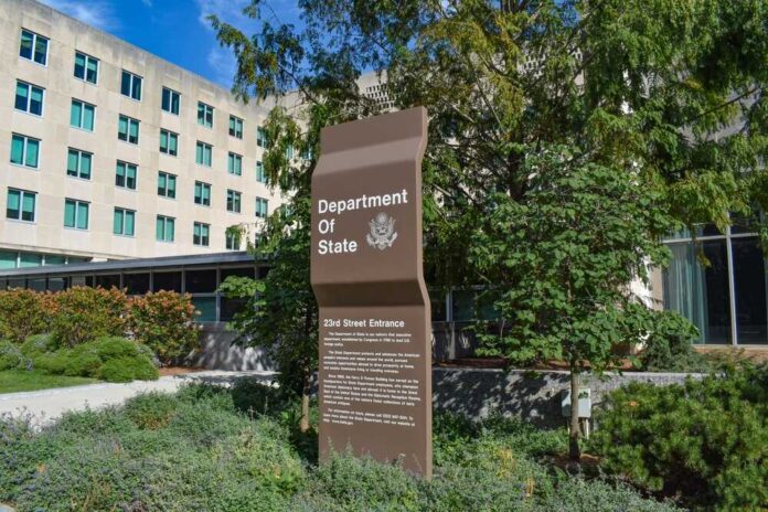 shutterstock_2063828270.jpg featured image Department of State entrance sign with surrounding greenery