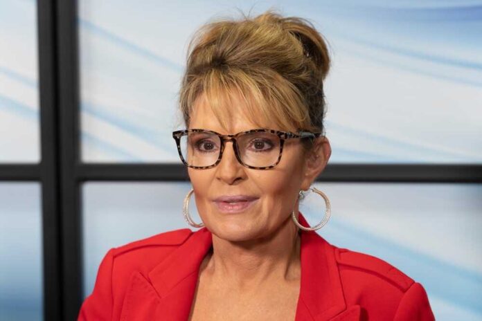shutterstock_2186586753.jpg featured image Sarah Palin glasses, red jacket, and background window.