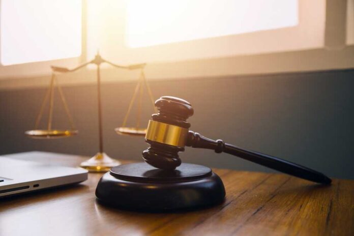 shutterstock_2347797923.jpg featured image Gavel and scales of justice on desk.