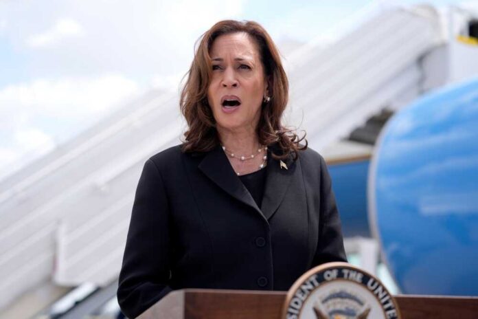 shutterstock_2497959729.jpg featured image Kamala Harris speaking in front of airplane stairs.