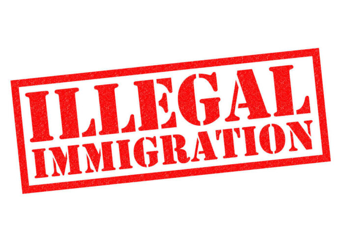shutterstock_368718257.jpg featured image Red illegal immigration stamp on white background