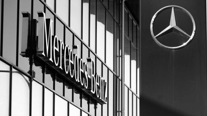 Mercedes Benz logo on building exterior in grayscale