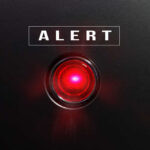 Red alert light on black background