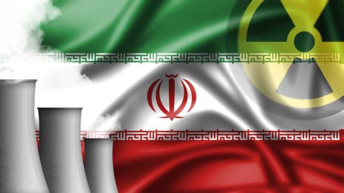 shutterstock_2038751381.jpg featured image Iran flag with nuclear symbol, cooling towers emitting smoke.