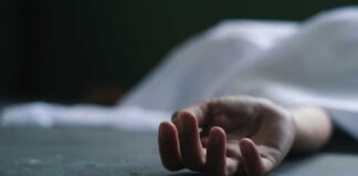 Close-up of a hand under a white sheet.