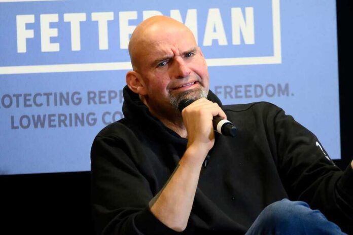 shutterstock_2222472661.jpg featured image John Fetterman holding microphone.