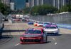 Stock car race on urban street circuit.