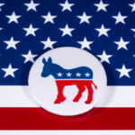 Democratic Party donkey logo on American flag background.