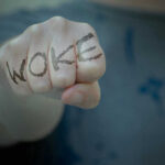 Fist with Woke written on fingers