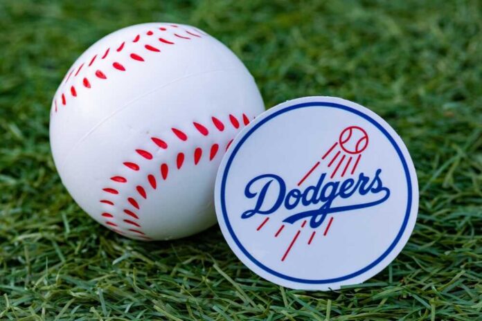 shutterstock_2206855723.jpg featured image Baseball and Dodgers logo on grass field