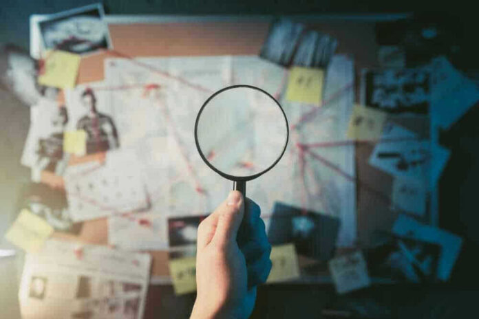 Magnifying glass over investigation board with photos and strings