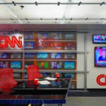 CNN newsroom with empty chairs and televisions