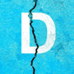 White letter D on cracked blue surface.