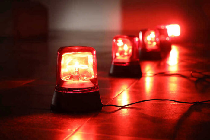 Red emergency lights on dark floor, illuminating the area