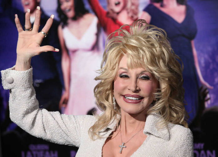 Dolly Parton waving and smiling