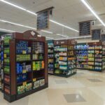 Interior view of a grocery store aisle with shelves of food and beverages