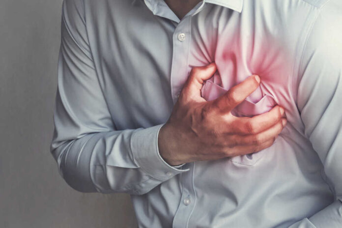 Man clutching his chest in distress, indicating pain