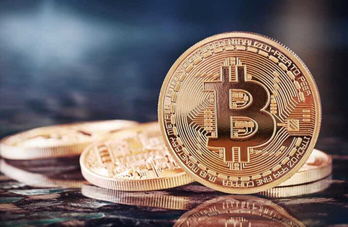 Bitcoin coins on a reflective surface