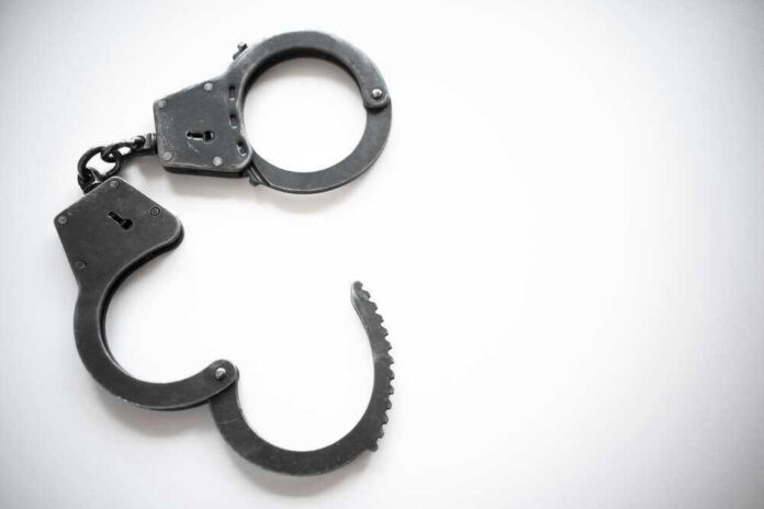 Open metal handcuffs on white background