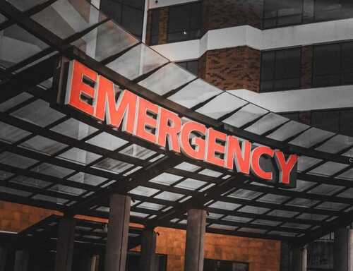 Illuminated emergency sign at a hospital entrance