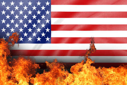 American flag partially engulfed in flames
