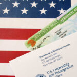 Permanent resident card and official letter on an American flag background