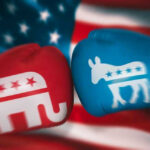 Red and blue boxing gloves with political party symbols.