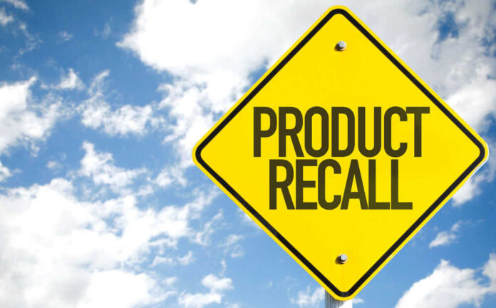 Yellow product recall sign against cloudy sky