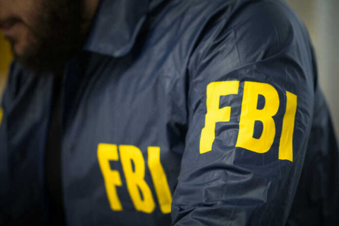 FBI agent in navy blue jacket.
