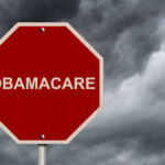 Red stop sign labeled Obamacare cloudy sky background