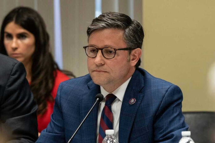 Mike Johnson in suit speaking.