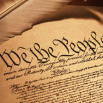 U.S. Constitution We the People with feather quill.