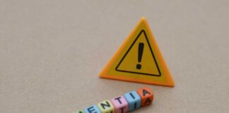 Colorful letter blocks spelling 'DEMENTIA' next to a warning sign