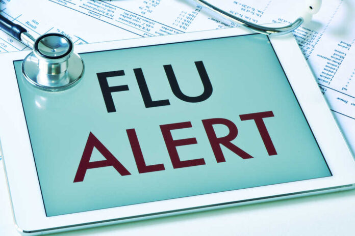 shutterstock_512002318.jpg Tablet displaying a flu alert message with a stethoscope nearby