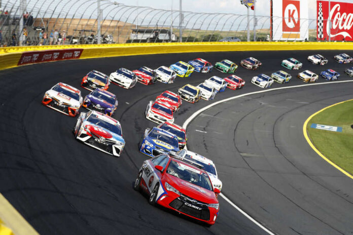 shutterstock_651212332.jpg Race cars on a track in formation driving fast
