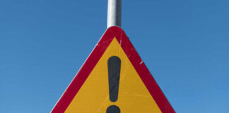 Triangular warning sign with exclamation mark.