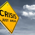 IRS Chaos: Workforce Slashed, Tax Delays Loom A yellow warning sign indicating a crisis ahead