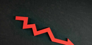 Red zigzag arrow pointing down on dark background.