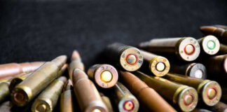Close-up of assorted rifle bullets on a dark background.