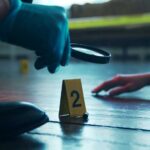 Serial Killer Exposed After 40 Years A detective examining evidence at a crime scene with markers on the floor