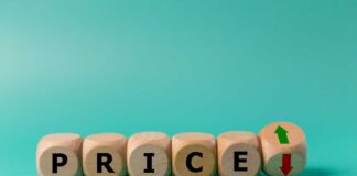 Wooden blocks spelling 'PRICE' with arrows indicating increase and decrease