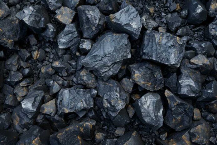 Close-up view of dark rocks with a shiny surface and golden flecks