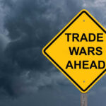 Yellow warning sign reads Trade Wars Ahead