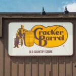 Cracker Barrel U-Turn: Fan Favorites BACK! Sign for Cracker Barrel Old Country Store featuring a man sitting on a barrel